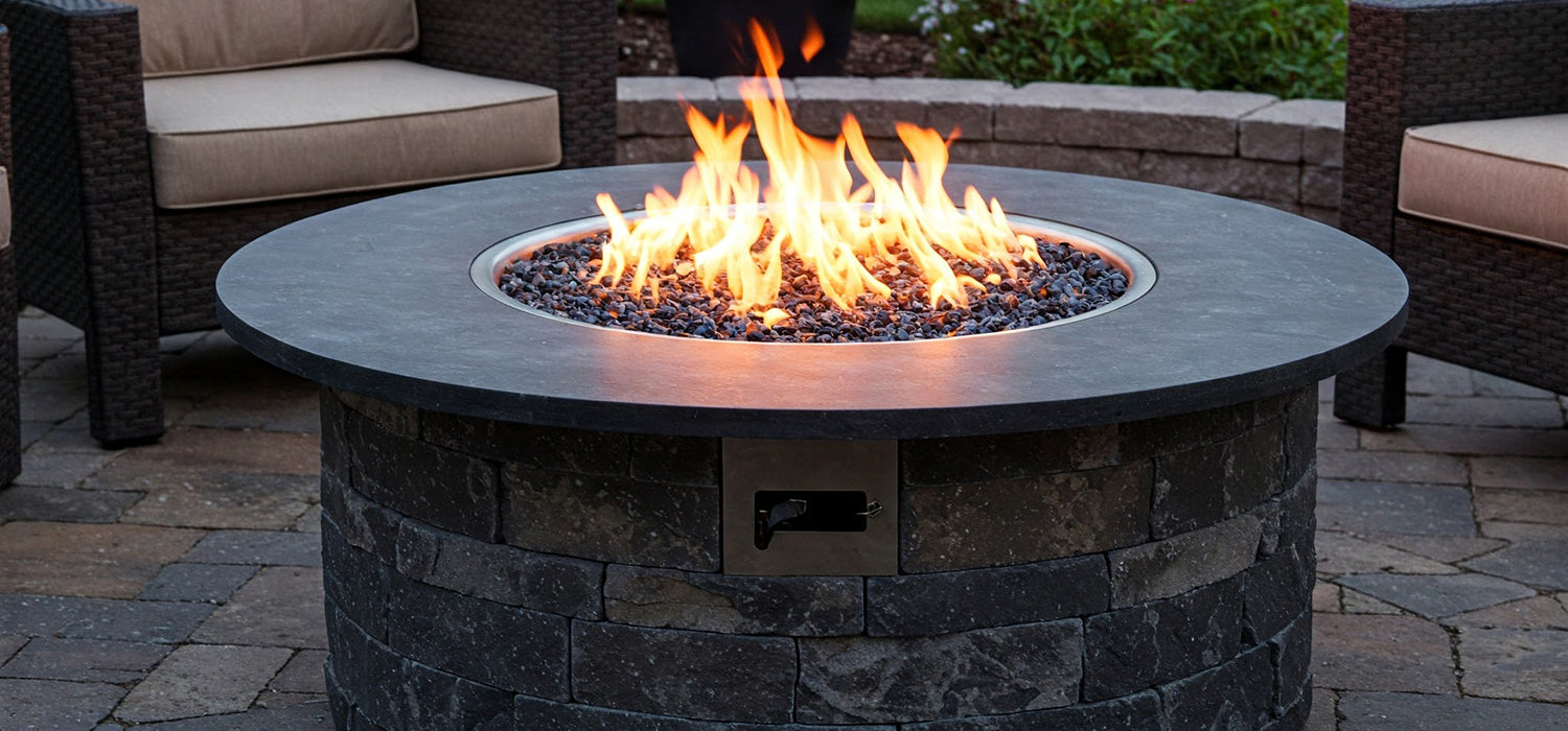 Stone gas fire pit ablaze.