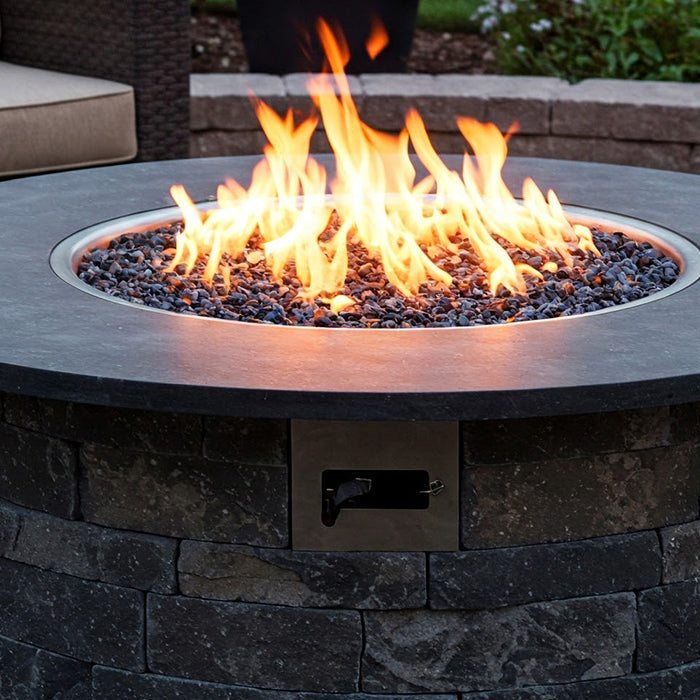 Stone gas fire pit ablaze.